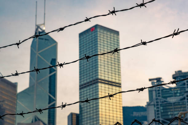 istock Corporate Building behind a fence with barbed wire at daylight 1313270945