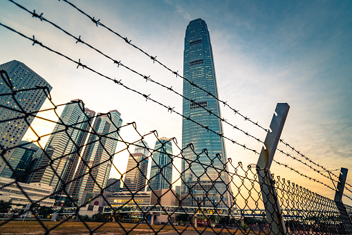 Corporate Building behind a fence with barbed wire at daylight