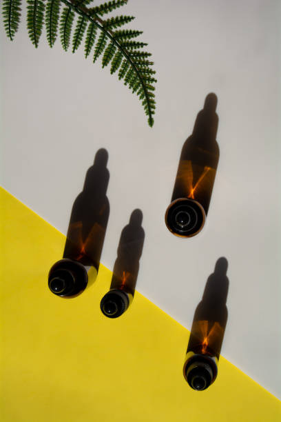 istock Set of bottles for cosmetics on yellow-white background with leaf 1313271444