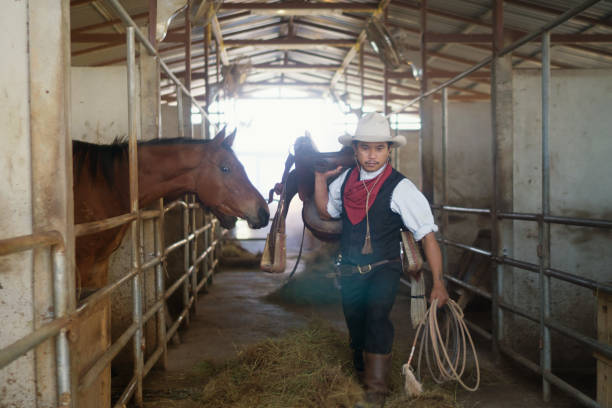 istock Cowboy Walking In Barn 1313275625