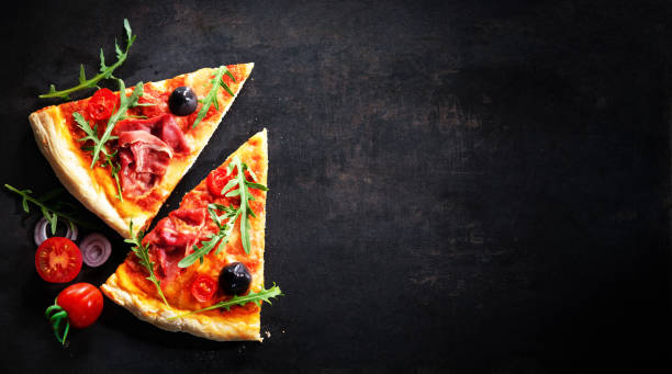 istock Delicious italian pizza on dark background 1313276450