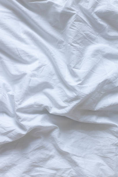istock White bed linen background with copy space. Home comfort concept. 1313278173