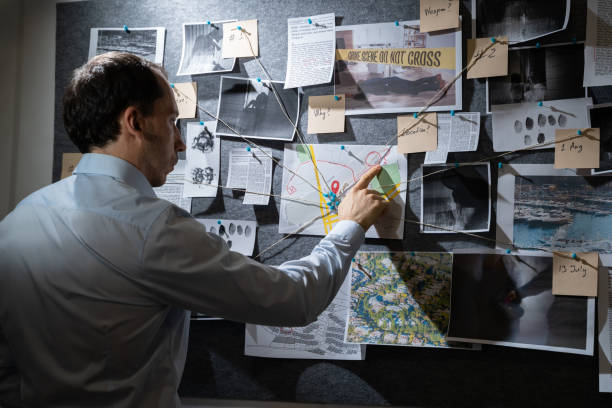 istock Policeman Searching Crime Investigation Board 1313279120