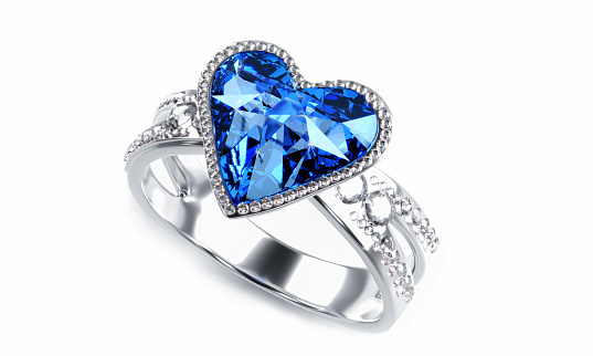 The large blue diamond heart shape is surrounded by many diamonds on the ring made of platinum gold placed on a gray background. Elegant wedding diamond ring for women.  3d rendering