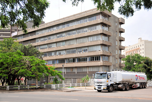 Accra, Ghana: tanker truck and Total House, the HQ of Total Ghana, branch of the French multinational oil and gas company, one of the seven Supermajor oil companies - Accra business district