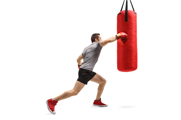 istock Strong man exercising and punching a boxing bag 1313281200