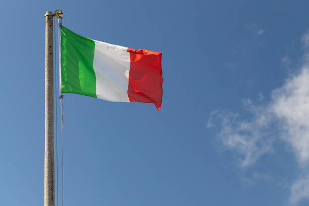 istock Italian flag blowing in the wind in the blue sky 1313281264