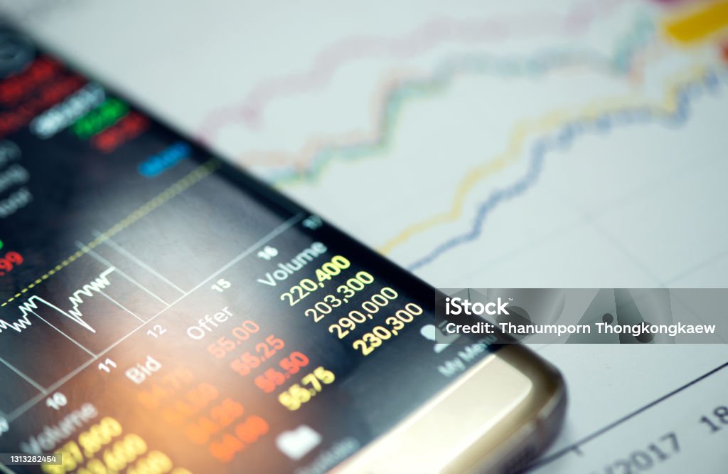 Trading online on the smart phone. New ways to make economy and trading. Selling Stock Photo