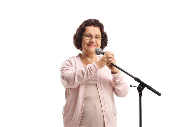 istock Elderly woman with a microphone 1313285720