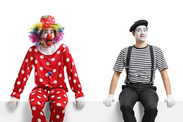 istock Clown and a mime sitting on a blank panel 1313285724