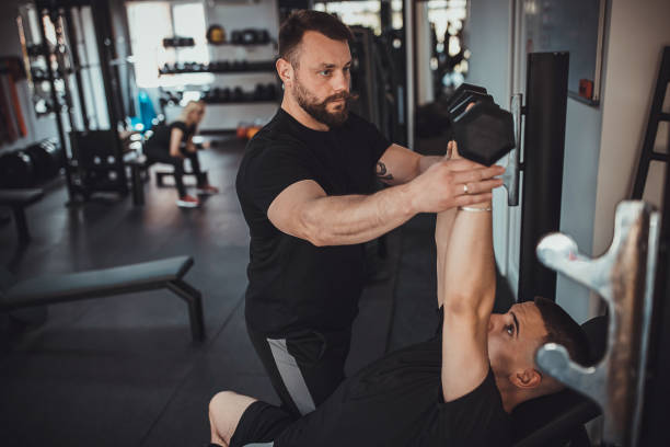 istock Man training with fitness instructor 1313287308