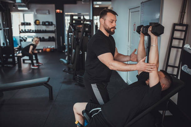 istock Man training with fitness instructor 1313287437