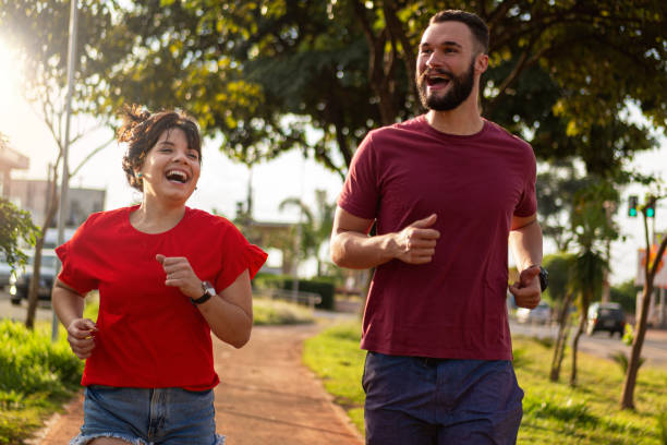 istock Young couple smiling and running. 1313292720