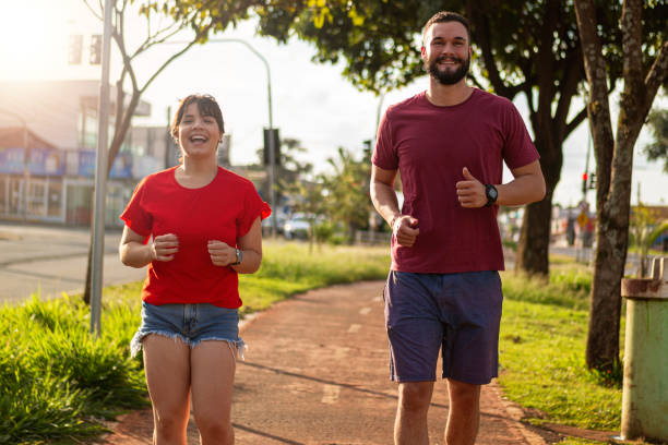 istock Young couple smiling and running. 1313292761