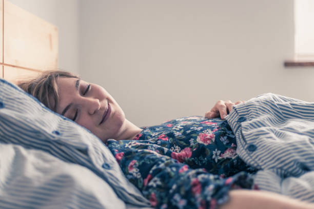istock Restful sleep: Young female is sleeping in her bed, close up 1313296336