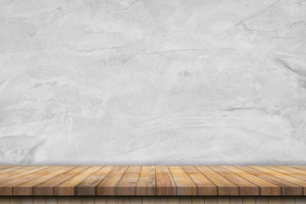 istock old cement wall interior vintage and wooden table background. 1313296992