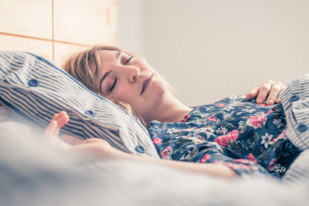 istock Restful sleep: Young female is sleeping in her bed, close up 1313297037
