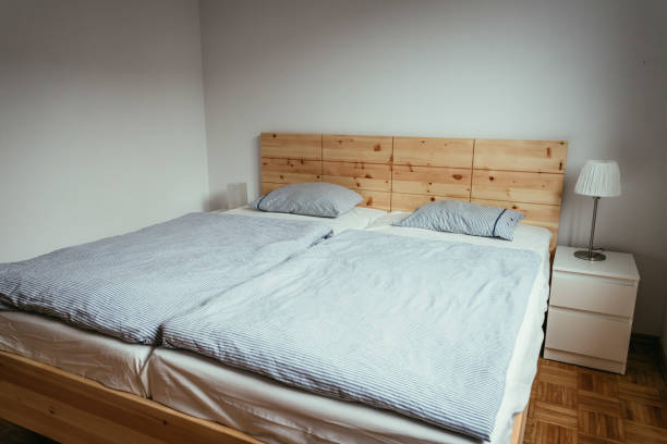 istock Stone pine bed: Empty wooden bed with pillow and blanket 1313297269