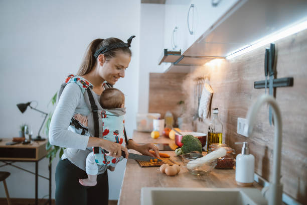 istock Multi-tasing single mother preparing a diner with her baby. 1313297849
