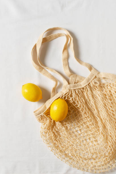 istock Zero waste concept with string bag, mesh bag, grosery bag with lemon on white background 1313300034