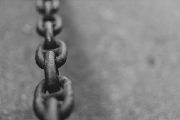 istock Black heavy metal chain on graphite asphalt background with copy space 1313300212