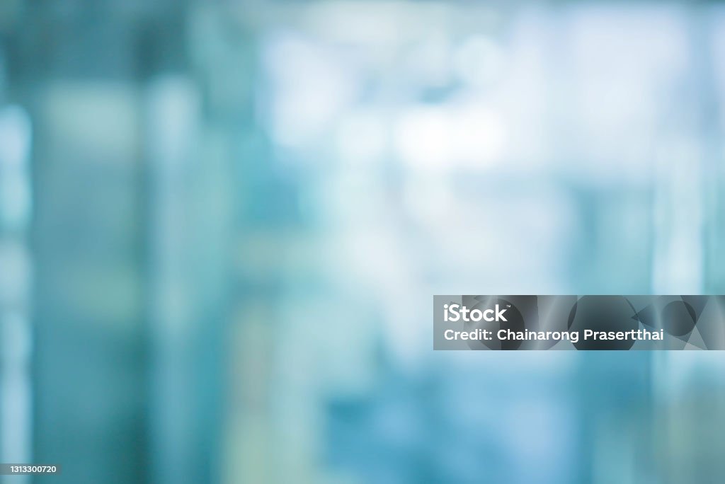 abstract blur soft focus blue color interior of modern cleaning workplace background with orange shine light for design concept Backgrounds Stock Photo