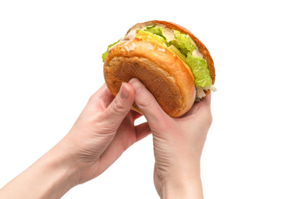 istock Hamburger in woman hands isolated on a white background. 1313301899