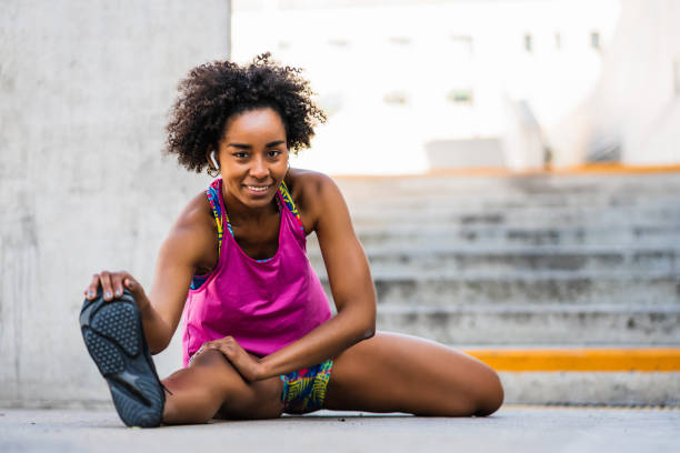 istock Afro athlete woman stretching legs before exercise. 1313302022
