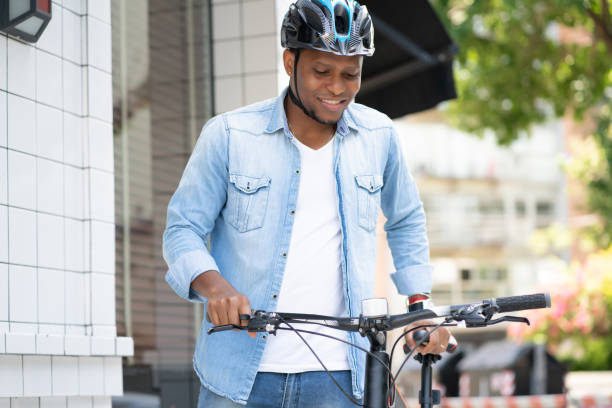 istock Man wearing a helmet while walking with a bicycle. 1313302137