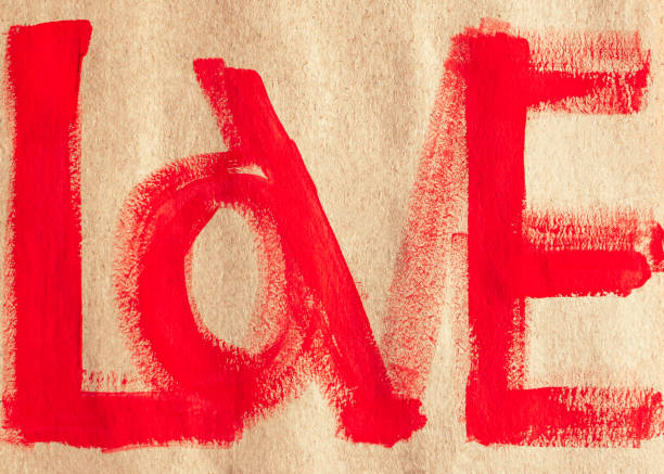 istock LOVE written on craft paper in red paint. Author's postcard for Valentine's Day, a confession of feelings. 1313302196