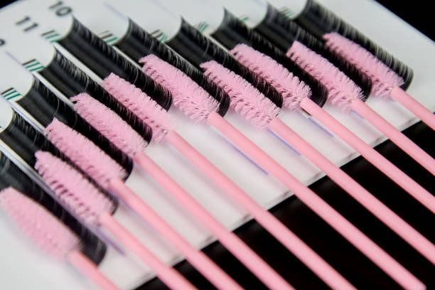 istock A tablet with false eyelashes and brushes on a black background. 1313304458