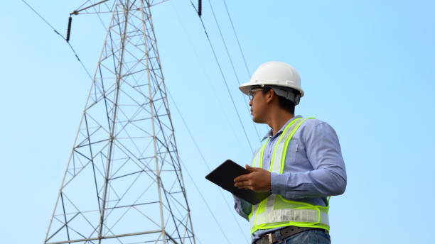 istock specialist electrical engineer working near to High voltage tower. 1313307301