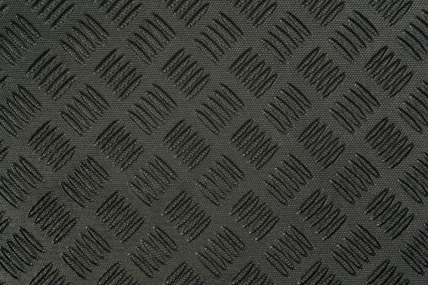 Closeup view stock photography of texture of black protective hdpe rug or mat for boot of automobile