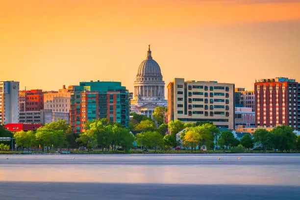 Madison, Wisconsin, USA downtown skyline at dusk on Lake Monona.