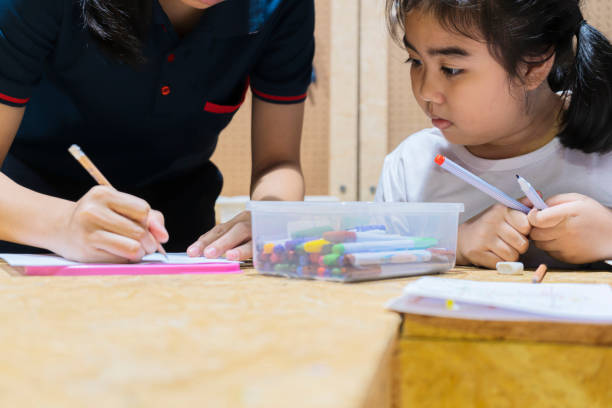 istock Many students and teachers holding learning structures from toys at playroom 1313313253