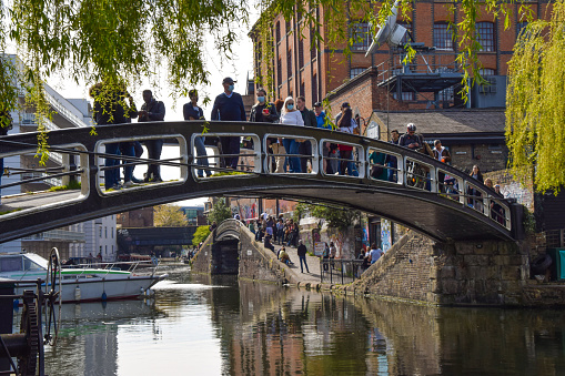 London, United Kingdom - 18th April 2021: Crowds enjoy the weather on Regent's Canal in Camden. People flocked outside over a busy weekend as lockdown rules are relaxed in England.
