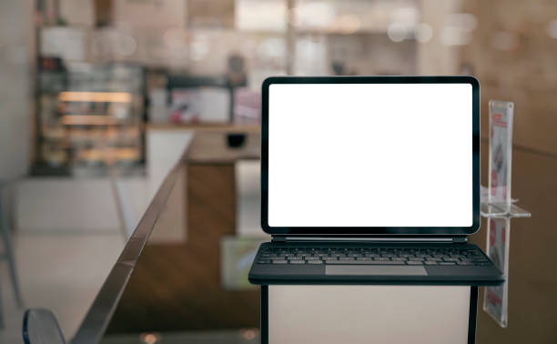 istock Mockup blank screen tablet with magic keyboard on the table in cafe. 1313313628