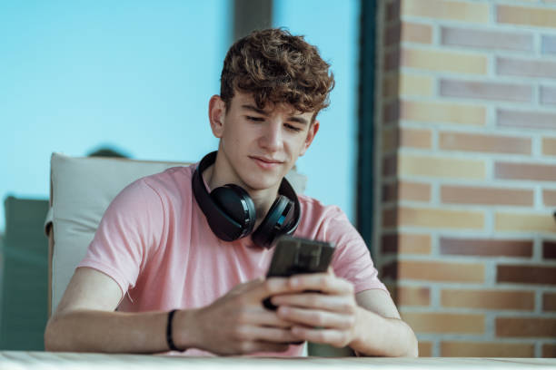 istock young man with headphones and smartphone in hand 1313314588