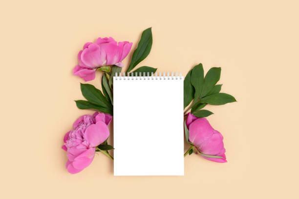 istock Blank notepad mockup with bouquet of peony flowers 1313316062