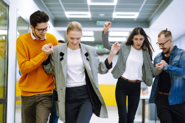 istock Young colleagues skateboarding. Friendly work team enjoying positive emotions. 1313316362