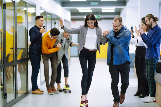 istock Young colleagues skateboarding. Friendly work team enjoying positive emotions. 1313316369