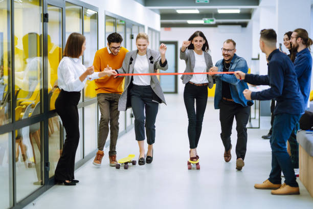 istock Young colleagues skateboarding. Friendly work team enjoying positive emotions. 1313316379