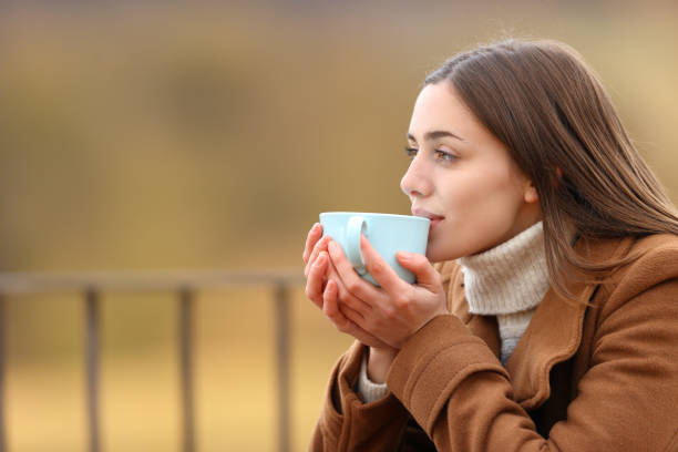 istock Woman drinking coffee in winter in a balcony 1313316505