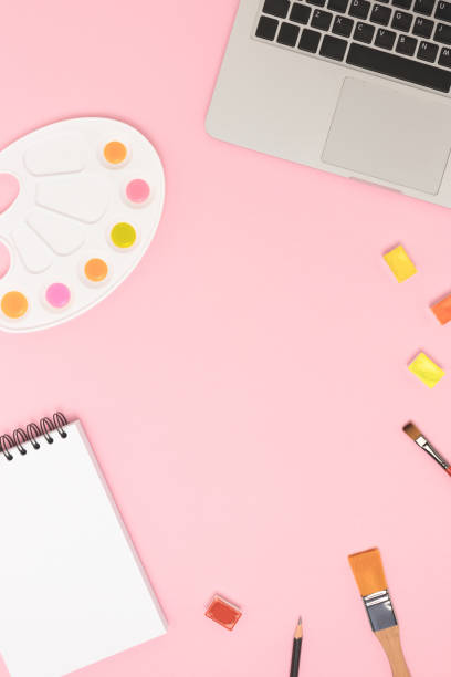 istock Top view of tools for painting on a pink background. 1313317034