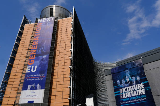 A poster of anti-vax movement in front of Berlaymont Building, the European Commission headquarters in the European district of Brussels, Belgium on April 19, 2021. A poster of anti-vax movement in front of Berlaymont Building, the European Commission headquarters in the European district of Brussels, Belgium on April 19, 2021. bill gates stock pictures, royalty-free photos & images