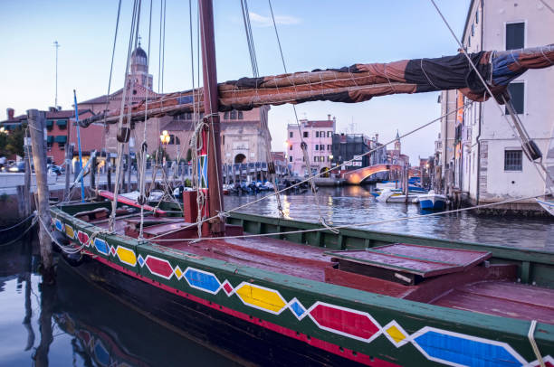 istock colorful boat at sunset 1313317546