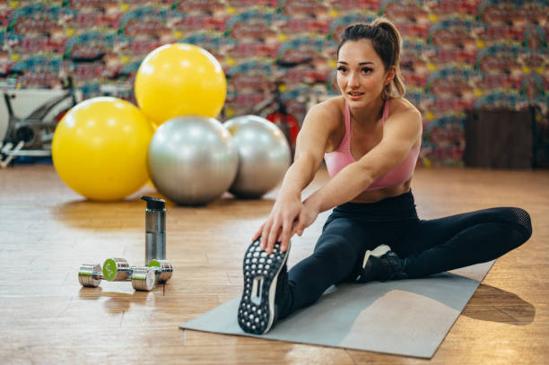 istock Woman stretching in the gym 1313319733