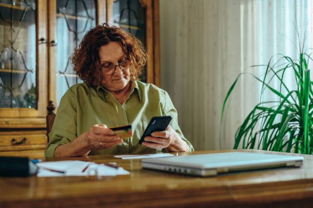 istock Senior woman using a smartphone at home 1313319741