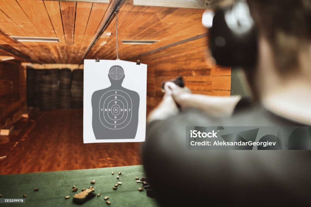 Focused Male Trying To Score High On Gun Practicing Range Target Shooting Stock Photo