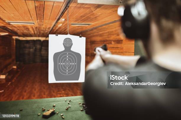 Focused Male Trying To Score High On Gun Practicing Range Stock Photo - Download Image Now